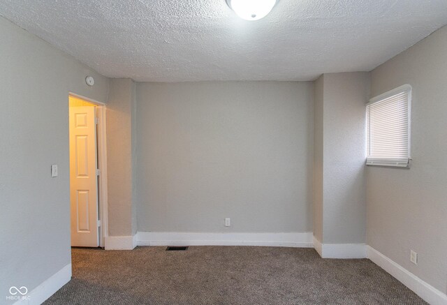 238-240 N Beville Ave, Indianapolis, IN 46201 - empty room featuring a textured ceiling, carpet, and baseboards