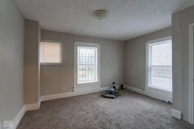 238-240 N Beville Ave, Indianapolis, IN 46201 - empty room with carpet floors, a textured ceiling, and baseboards