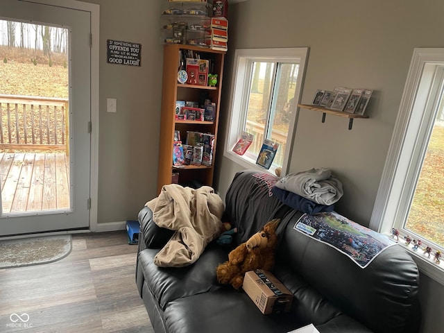 interior space with baseboards and wood finished floors