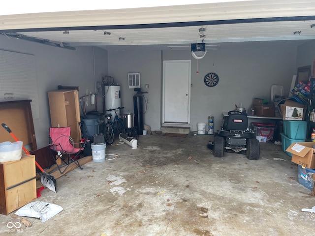 garage featuring water heater and a garage door opener