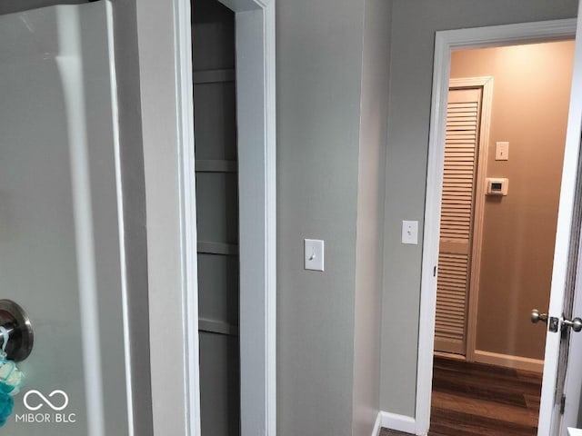 interior space with dark wood finished floors and baseboards