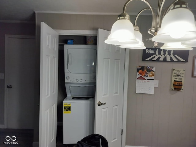 interior space with crown molding, laundry area, and stacked washer / drying machine