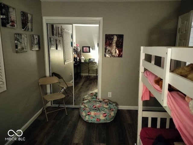 bedroom featuring dark wood finished floors and baseboards