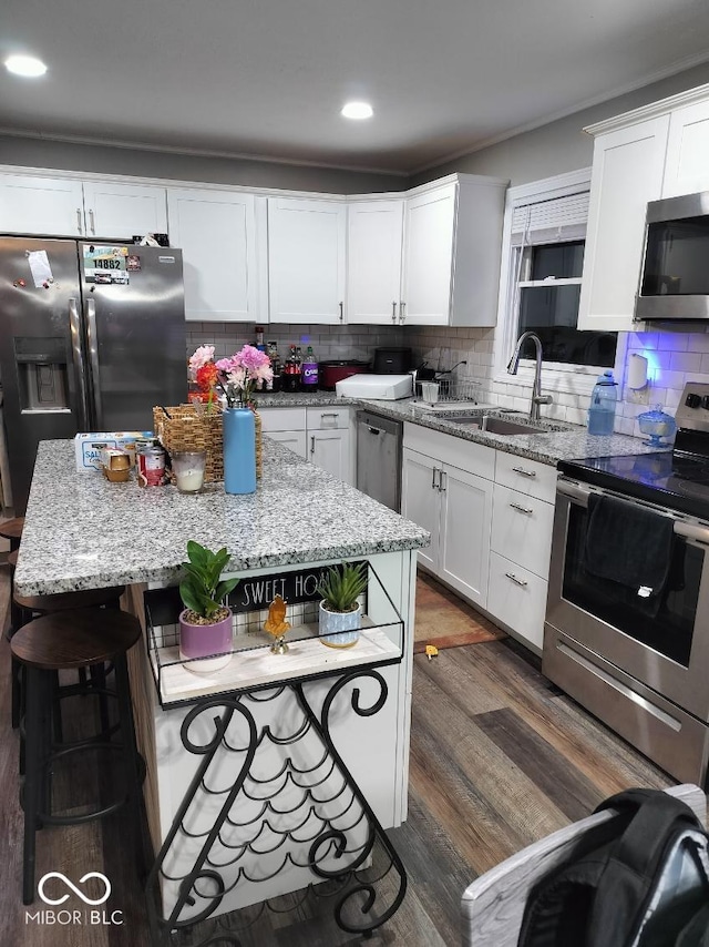 kitchen featuring appliances with stainless steel finishes, a sink, and decorative backsplash