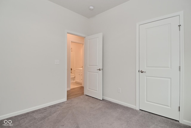 unfurnished bedroom with carpet and baseboards