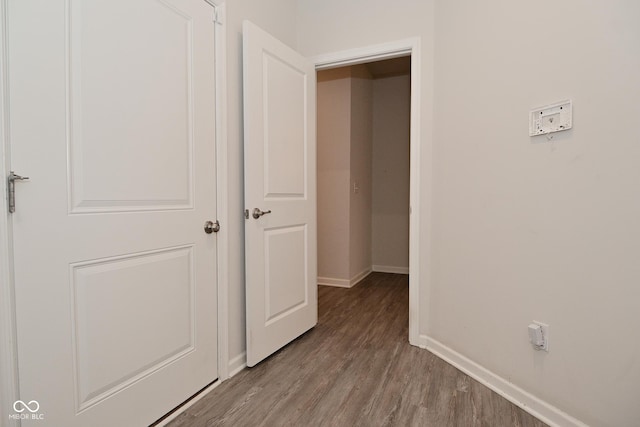 interior space with wood finished floors and baseboards