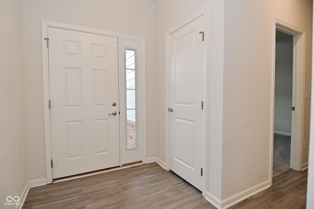 foyer featuring wood finished floors and baseboards