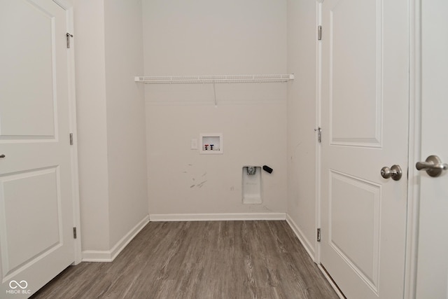 washroom featuring hookup for a washing machine, hookup for an electric dryer, laundry area, baseboards, and dark wood finished floors