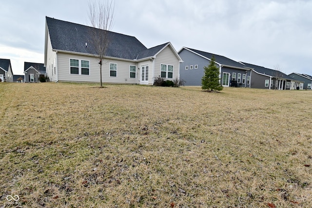 rear view of house featuring a lawn