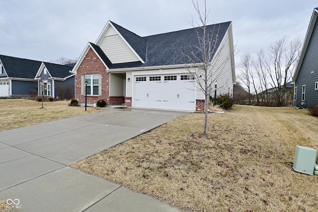 view of front facade featuring a front lawn, brick siding, driveway, and an attached garage