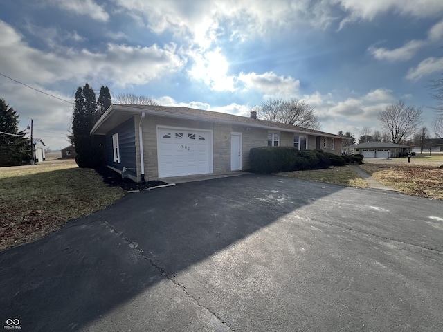 view of front facade with a garage and aphalt driveway