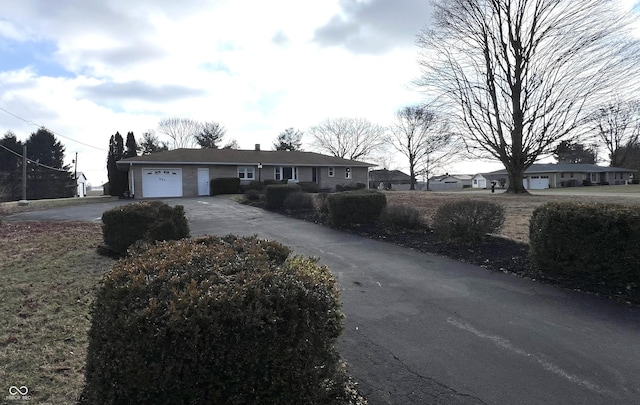 single story home with a garage and concrete driveway