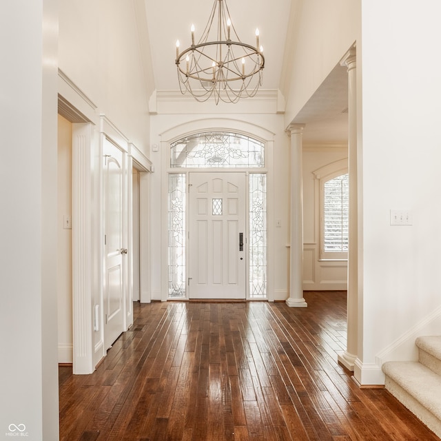 6560 Dawson Lake Dr, Indianapolis, IN 46220 - entrance foyer with dark wood-style flooring, a chandelier, stairway, decorative columns, and a high ceiling