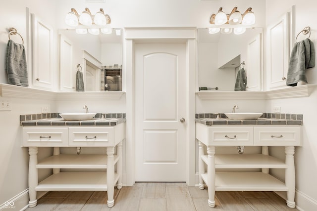 6560 Dawson Lake Dr, Indianapolis, IN 46220 - full bathroom featuring vanity, baseboards, and wood finished floors