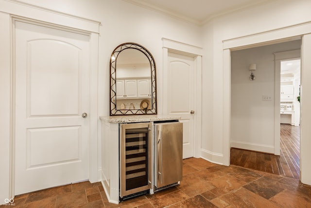 6560 Dawson Lake Dr, Indianapolis, IN 46220 - hall featuring beverage cooler, ornamental molding, stone tile flooring, and baseboards