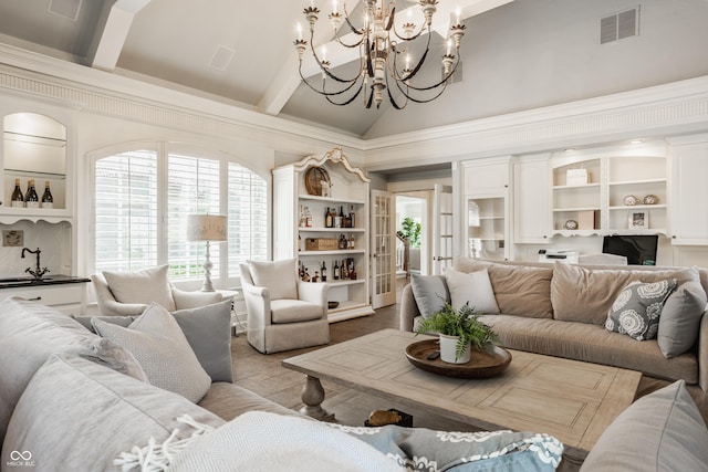 6560 Dawson Lake Dr, Indianapolis, IN 46220 - living area with high vaulted ceiling, a chandelier, beam ceiling, and built in shelves