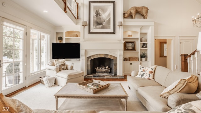 6560 Dawson Lake Dr, Indianapolis, IN 46220 - living room featuring a fireplace, a chandelier, built in features, and wood finished floors