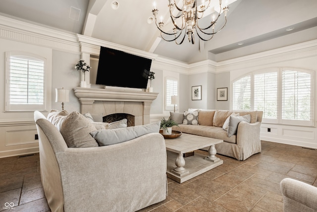 6560 Dawson Lake Dr, Indianapolis, IN 46220 - living room featuring stone tile flooring, a decorative wall, a tiled fireplace, a chandelier, and high vaulted ceiling