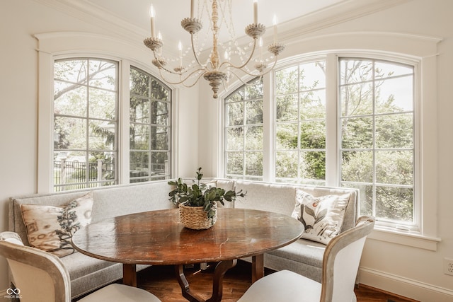 6560 Dawson Lake Dr, Indianapolis, IN 46220 - dining space featuring breakfast area, healthy amount of natural light, a chandelier, ornamental molding, and wood finished floors