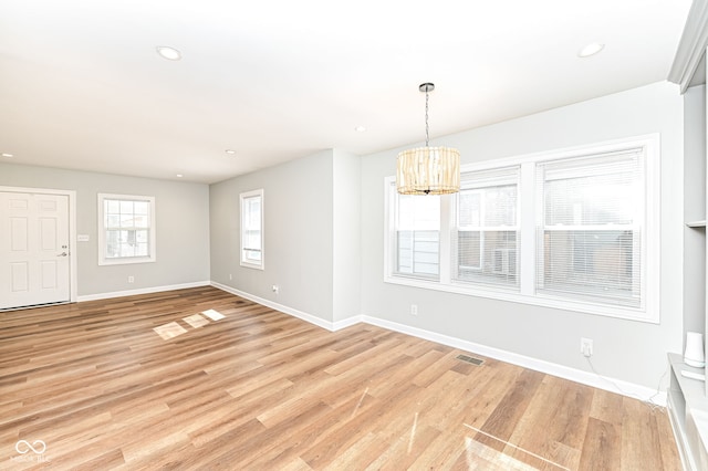 spare room featuring recessed lighting, baseboards, and light wood-style floors