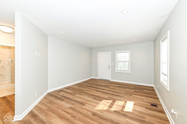 unfurnished room featuring recessed lighting, visible vents, baseboards, and light wood finished floors