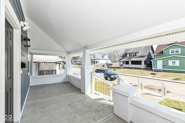 view of patio featuring a residential view and a porch