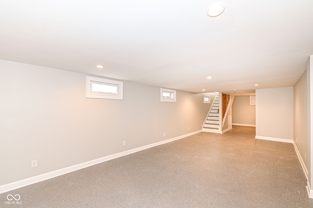 basement with recessed lighting, stairway, and baseboards