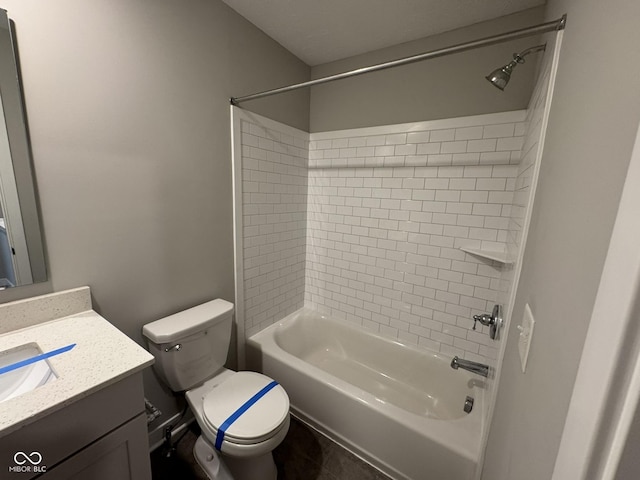 full bathroom featuring washtub / shower combination, vanity, and toilet