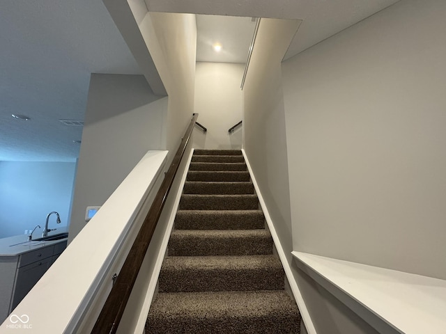 staircase featuring baseboards