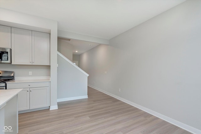 1274 Newton St, Avon, IN 46123 - kitchen featuring light wood finished floors, stainless steel appliances, light countertops, and baseboards