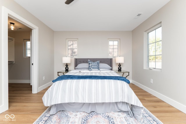 bedroom featuring baseboards, visible vents, and light wood-style floors