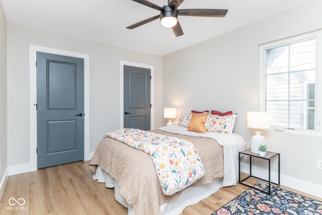 bedroom with ceiling fan, baseboards, and wood finished floors