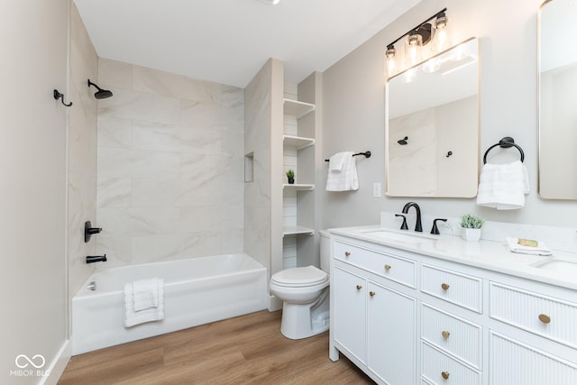 full bathroom with toilet, shower / washtub combination, wood finished floors, and vanity