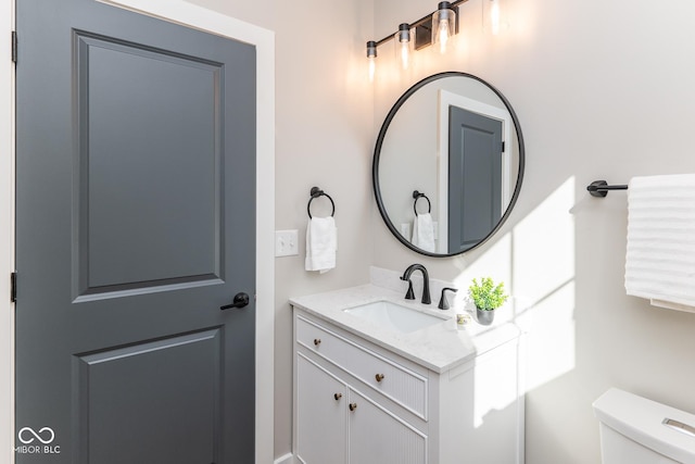 bathroom featuring toilet and vanity