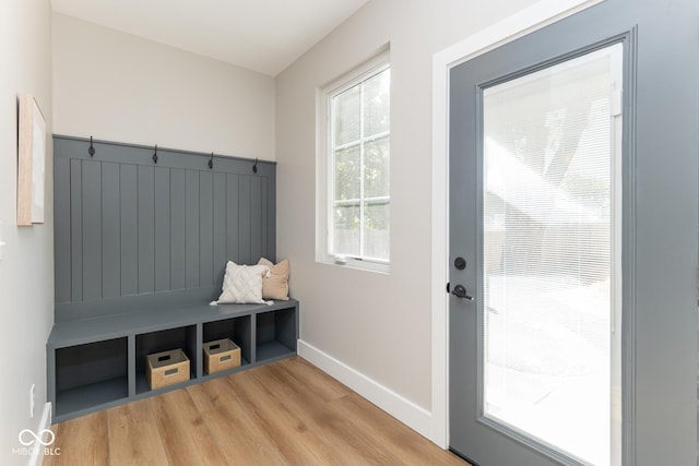 mudroom with light wood finished floors and baseboards