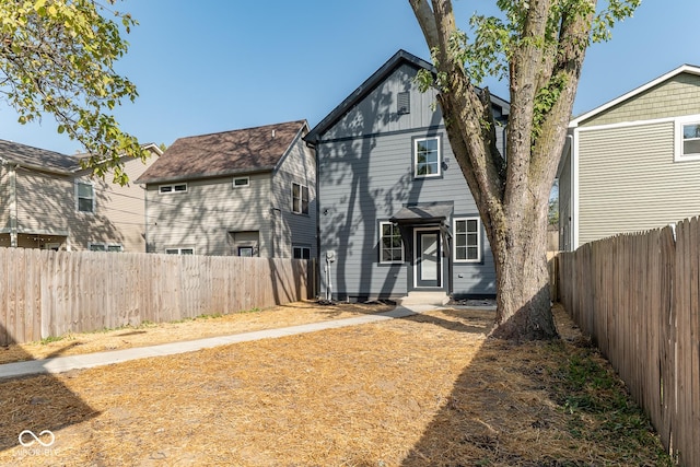 back of property with a fenced backyard