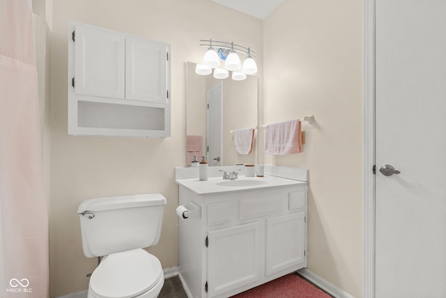 full bath featuring toilet, baseboards, and vanity