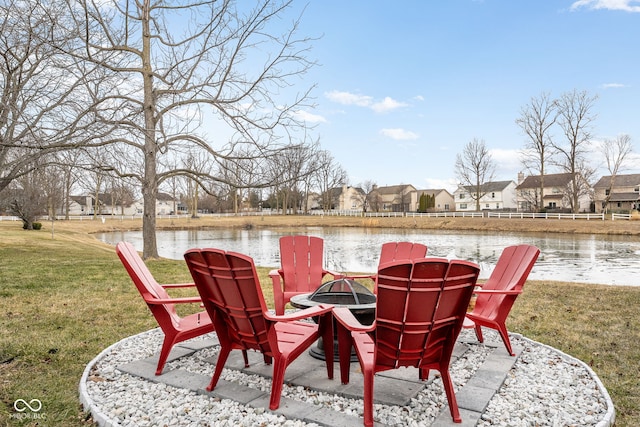 view of patio / terrace with a fire pit and a water view