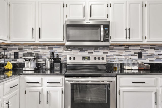 kitchen featuring stainless steel appliances, decorative backsplash, and white cabinets