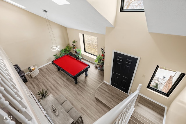 entrance foyer featuring high vaulted ceiling, billiards, baseboards, and wood finished floors