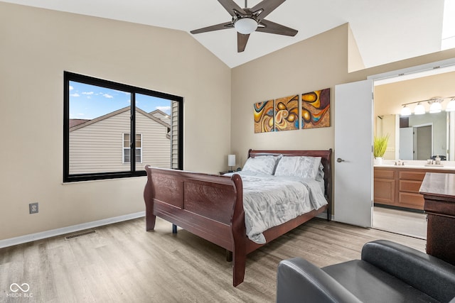 bedroom featuring lofted ceiling, baseboards, visible vents, and light wood finished floors