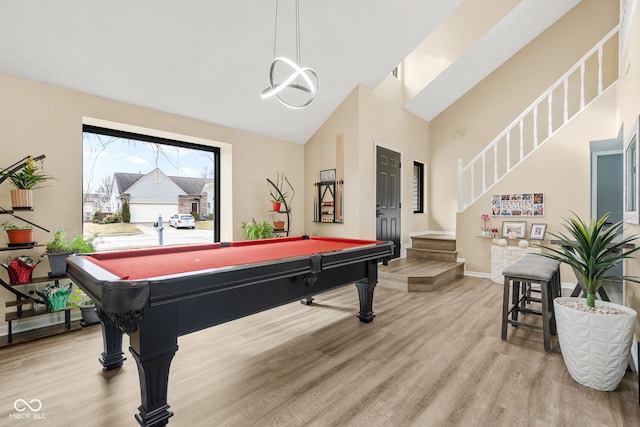 game room featuring high vaulted ceiling, baseboards, wood finished floors, and pool table