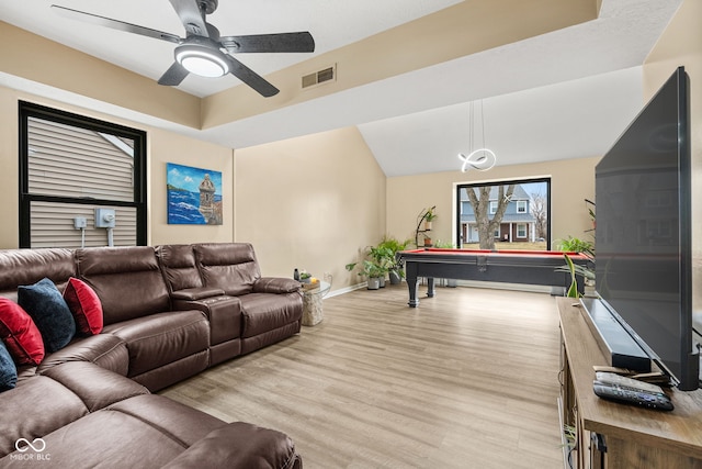 living room with light wood-style floors, visible vents, ceiling fan, and baseboards