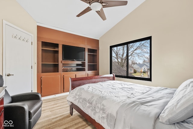 bedroom featuring light wood-style floors, vaulted ceiling, and a ceiling fan