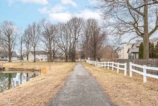 view of street featuring a residential view and a water view