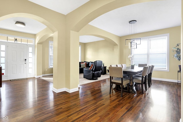 dining area featuring dark wood-style floors and baseboards