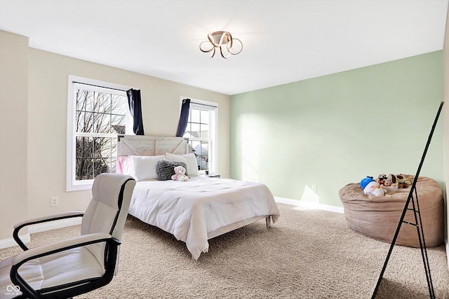 carpeted bedroom featuring baseboards