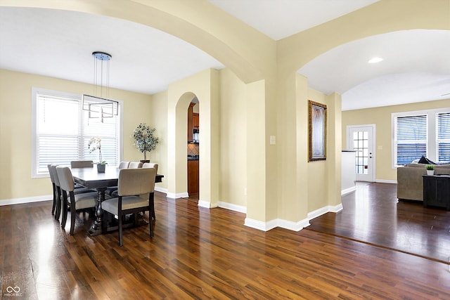 dining space with dark wood-style floors and baseboards