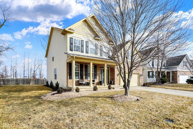 traditional-style home featuring a porch, fence, a garage, driveway, and a front lawn