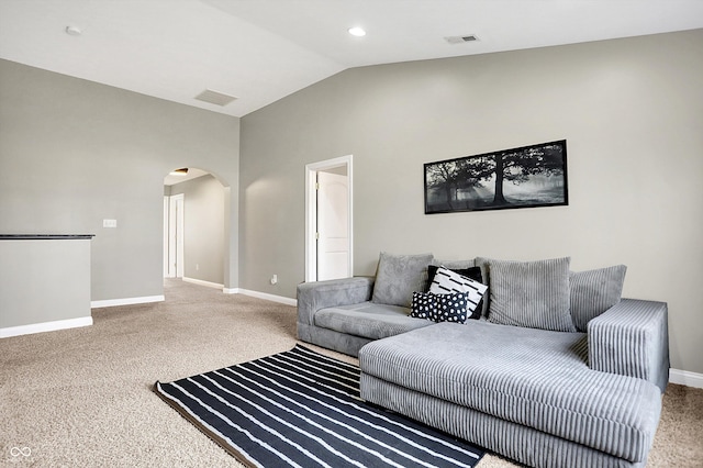 living room featuring arched walkways, visible vents, vaulted ceiling, and baseboards